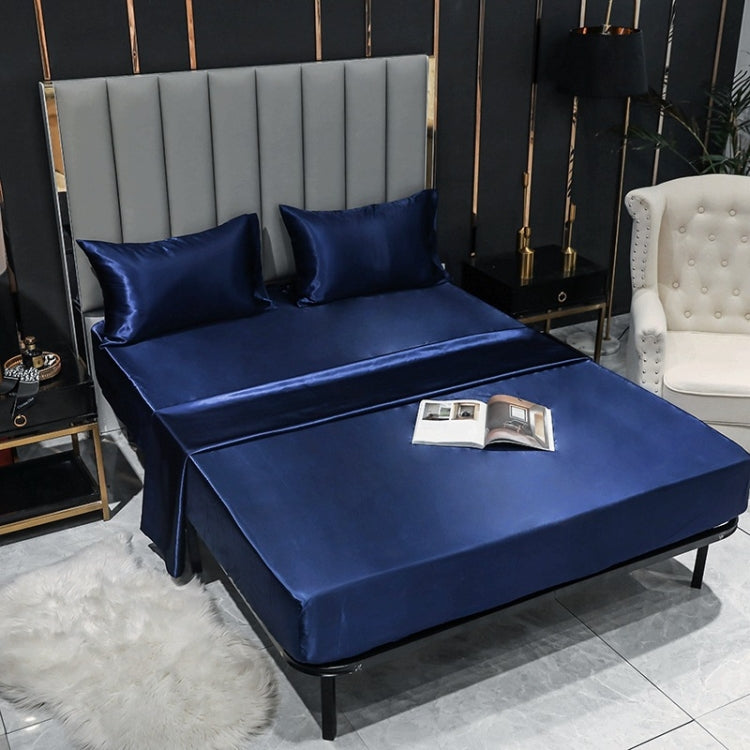 Blue satin pillowcase set with matching pillow covers on a bed