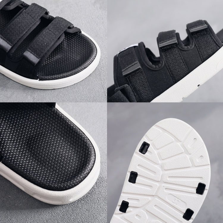 Black slip-on sneakers with textured upper, hook-and-loop strap, and cushioned sole