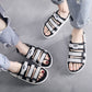 Men's black slide sandals with white-striped straps, open toe, adjustable hook-and-loop