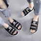 Black men’s slide sandals with adjustable hook-and-loop straps and open toe