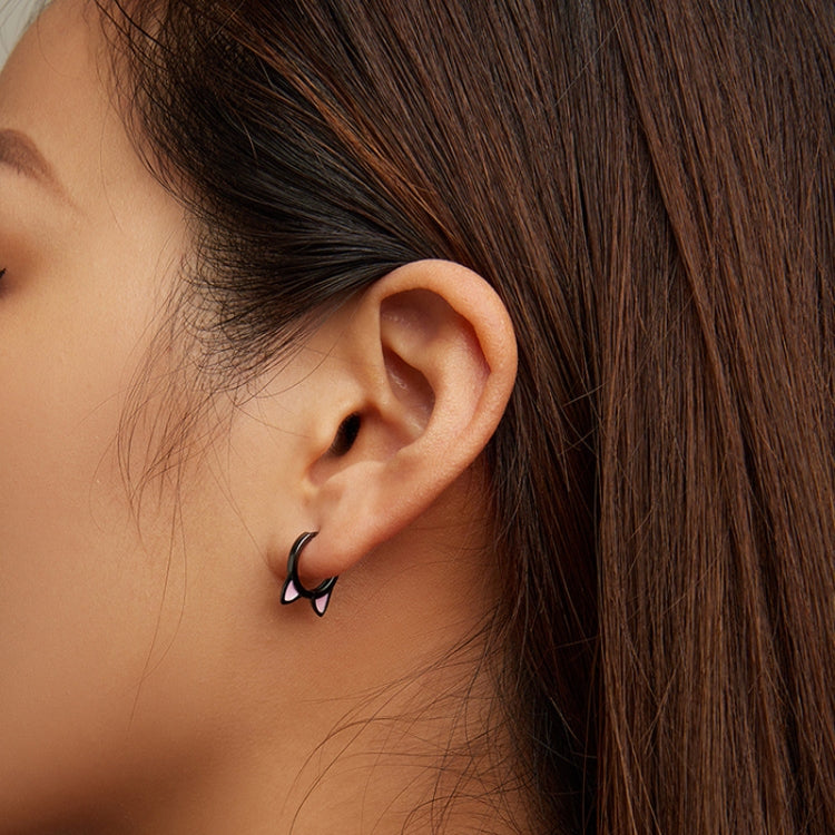 Cat-ear hoop earrings worn on ear, dark silver metal with pink inner accents