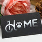 Matte black vinyl lettering sticker with white paw and text design