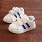 Kids white sneakers with blue side stripes and two hook-and-loop straps