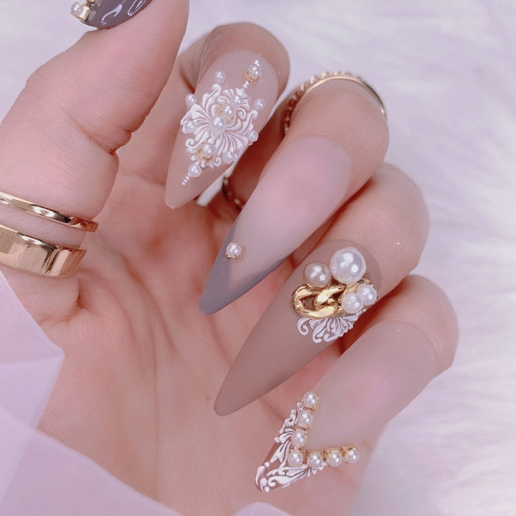 Decorated press-on style nails with 3D carved floral stickers in pearl and light purple