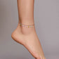 Silver anklet with multicolor heart charms on the ankle