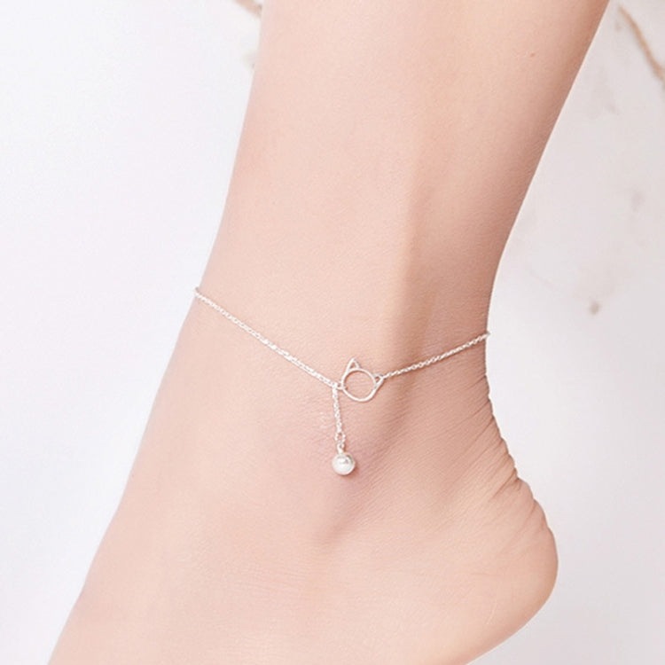 Silver cat bell anklet on ankle with small bell and ring-style clasp