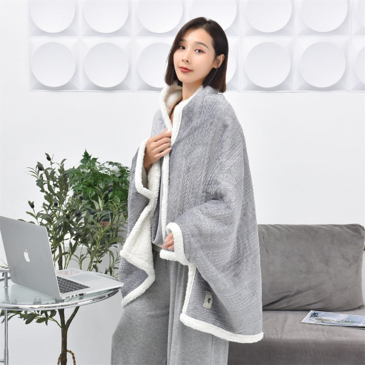 Flannel shawl blanket in light grey with white fleece trim, worn like a cape