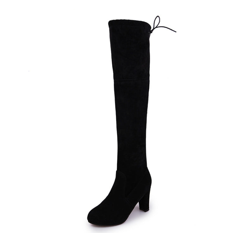 Black over-the-knee boots with thick heel and side tie detail
