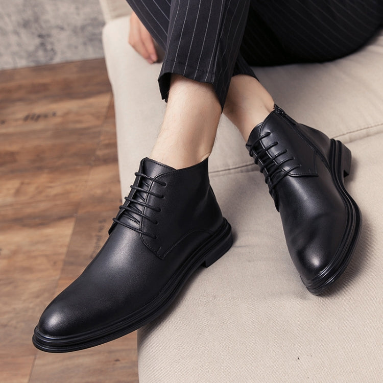 Men's black leather lace-up ankle boots with pointed toe, worn with dark trousers