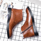 Men's brown leather lace-up boots with side zipper pull tab and thick black sole