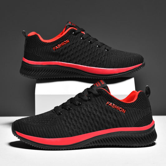 Black knit lace-up running shoes with red trim and textured sole, pair on display