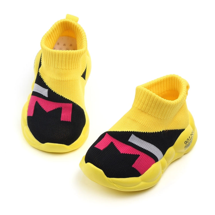 Pair of kids yellow knit walking shoes with black and pink geometric panel, cushioned sole