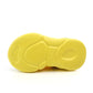Kids shoe outsole view with textured yellow rubber tread