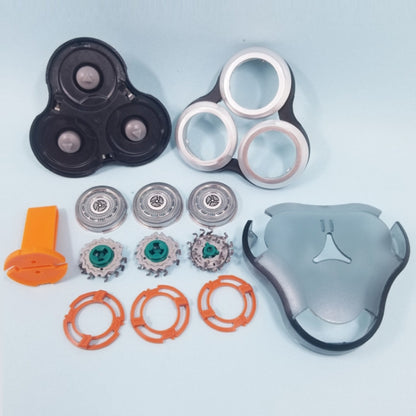 3-head head shaver with black housing, silver foils, and orange cutting rings