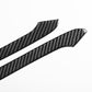 Close-up of two carbon-fiber look rearview mirror trim stickers with textured pattern