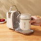 Insulated tote bag with open zip, gray interior lining, holding a cream soup cup