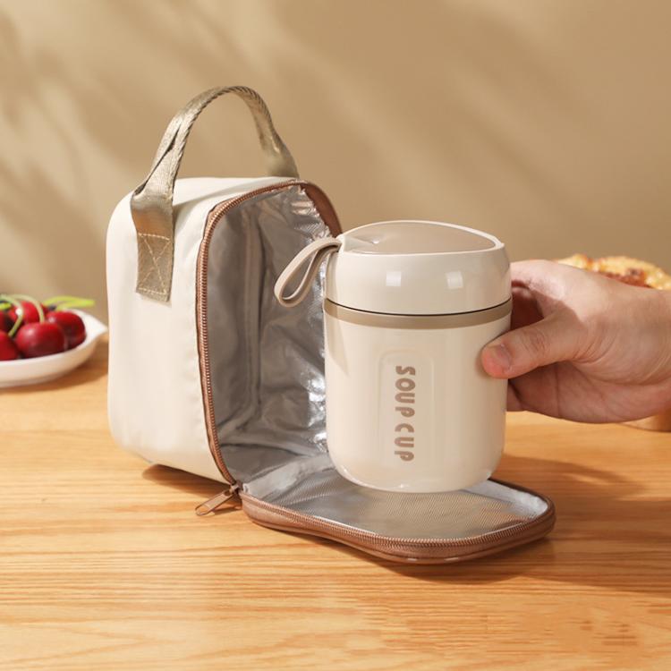 Insulated tote bag with open zip, gray interior lining, holding a cream soup cup