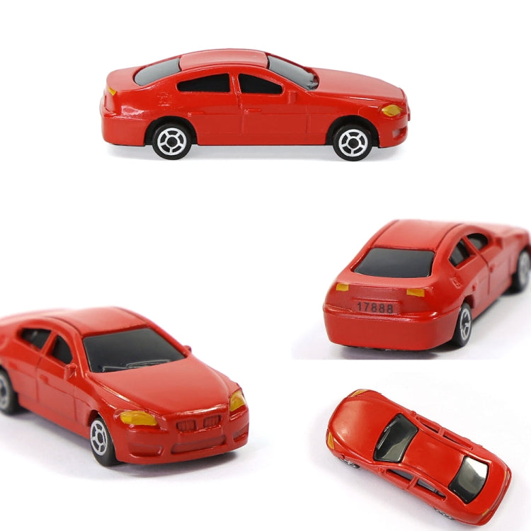 Close-up of a red small model car with detailed wheels and headlights