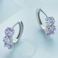 Silver hoop earrings with purple round zirconia clusters, side view