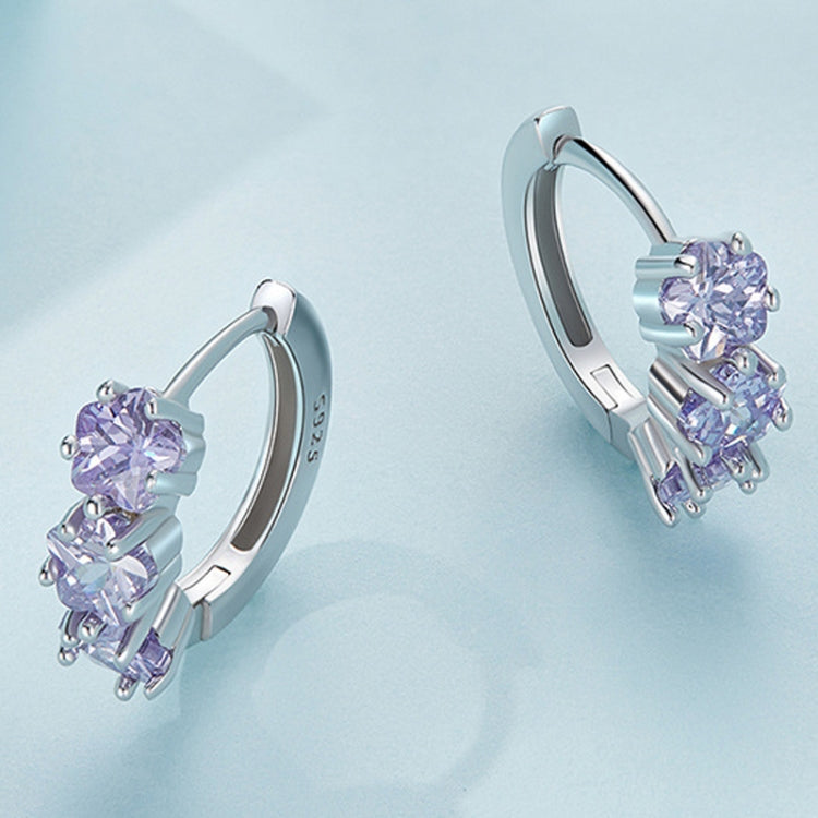 Silver hoop earrings with purple round zirconia clusters, side view