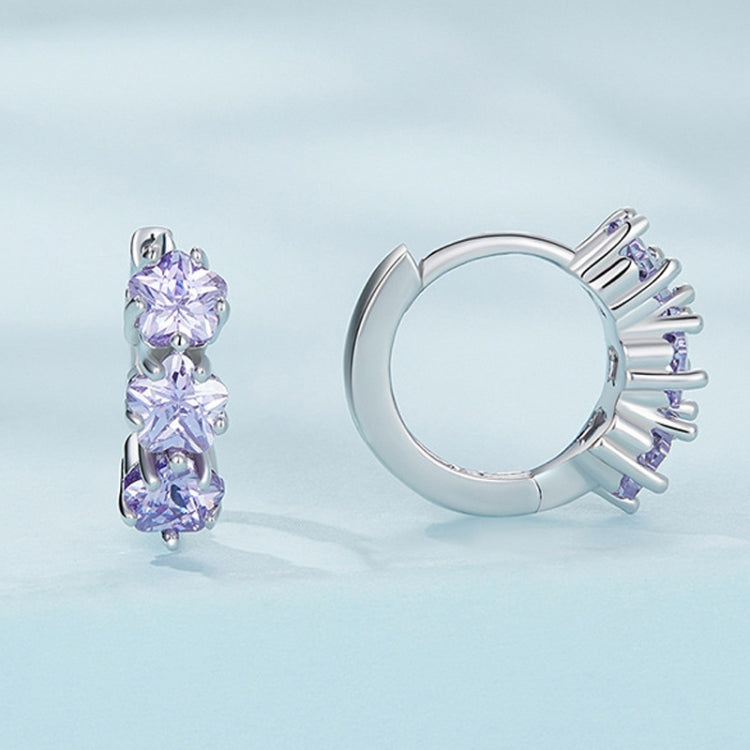 Pair of silver hoop earrings with three purple zirconia stones