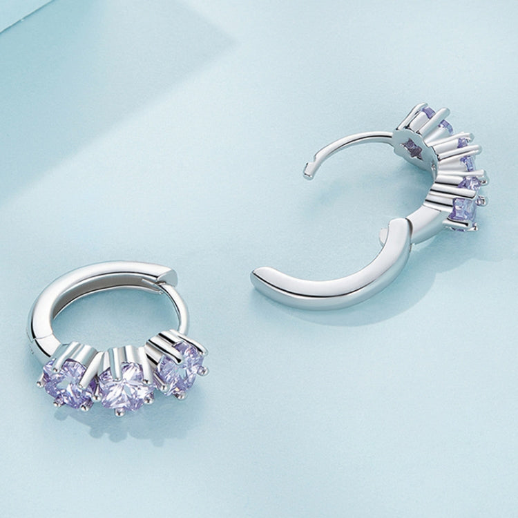 Silver hoop earrings with purple zirconia clusters, angled view of backs