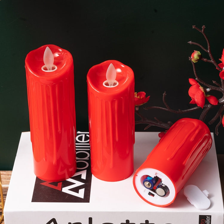 Red LED flameless candle set with one candle showing battery/electronics compartment at base.