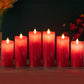 Row of red LED flameless candles with glowing wick tips, decorative display of multiple candles.