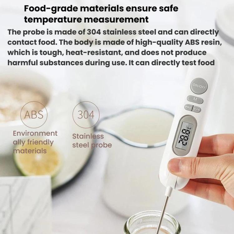 White digital food thermometer held over a pot, stainless steel probe