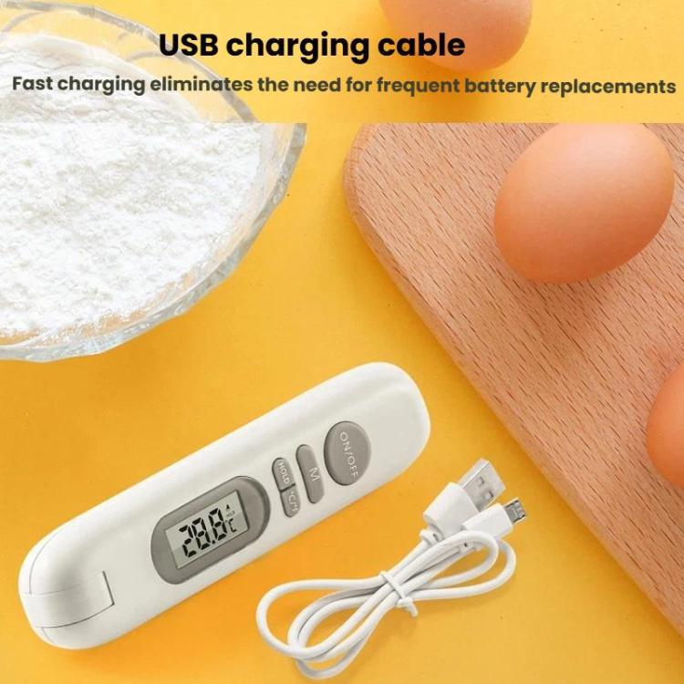 White digital food thermometer with USB charging cable on tabletop