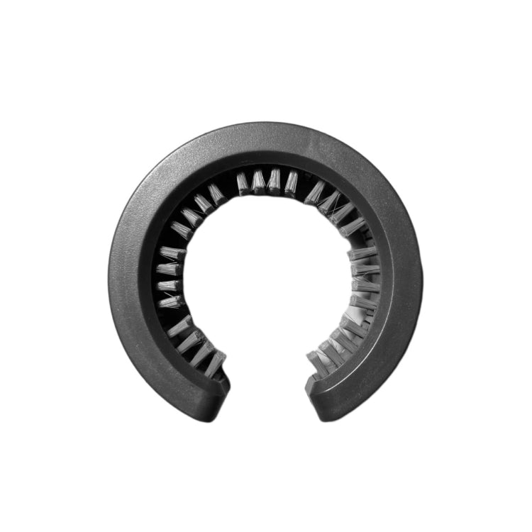 Gray cylindrical brush attachment with dense black bristles around the inner ring
