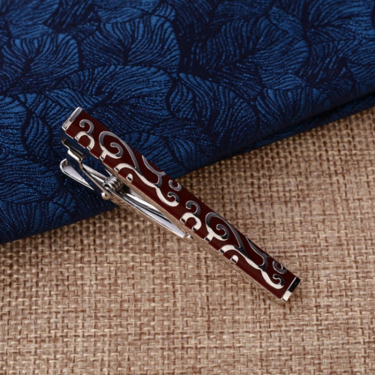 Blue-and-red swirl patterned tie clip with silver frame and hinged back
