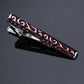 Black tie clip with burgundy red swirl pattern and silver-tone borders, hinged clasp.