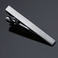 Silver tie clip with grid-pattern bar and black inner hinge detail