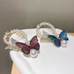 Pair of butterfly hair clips: blue and purple with pearl beaded frames and comb teeth