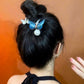 Blue butterfly hair clip on bun hairstyle with pearl bead and comb grips