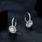 Sterling silver drop earrings with round halo moissanite stones