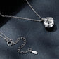 Silver chain pendant close-up with round halo moissanite setting
