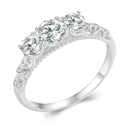 Sterling silver ring with ornate filigree band and five round moissanite-style stones