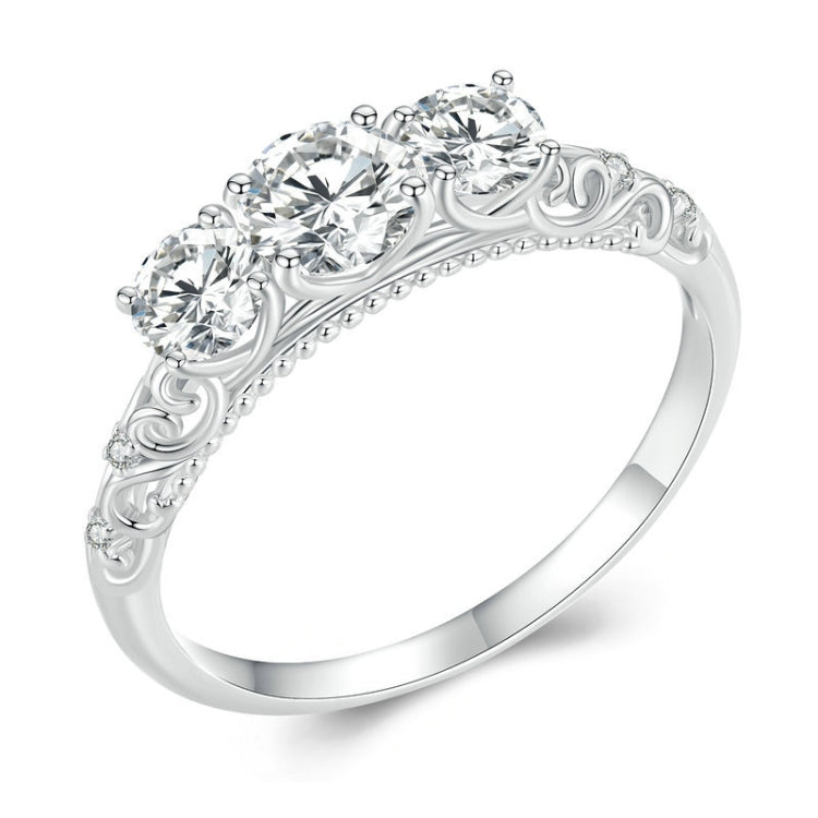 Sterling silver ring with filigree scrollwork band and five round moissanite-style stones