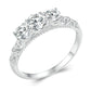 Sterling silver ring with engraved scroll band and five round moissanite-style stones