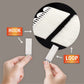 White hook-and-loop picture hanging strip, close-up with hands