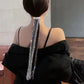 Rhinestone chain fringe hair band on back hair with long draping strands.