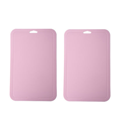 Pink plastic cutting boards with hanging holes, set of two