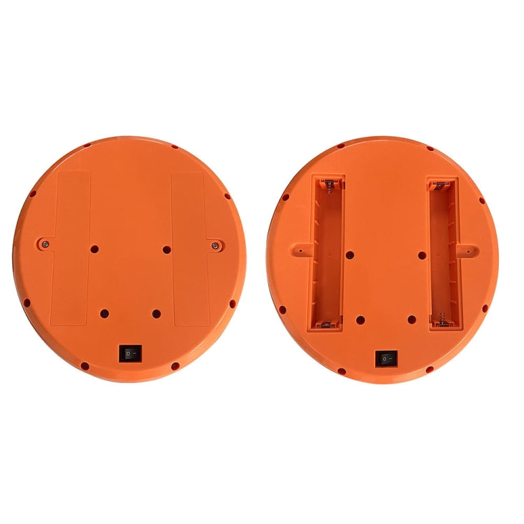 Bottom view of white and orange ball launcher with battery cover and ports.