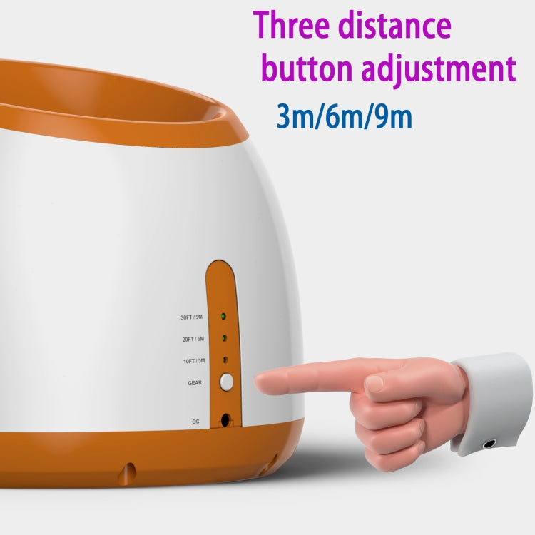 White and orange ball launcher with distance adjustment buttons and directional indicator lights.