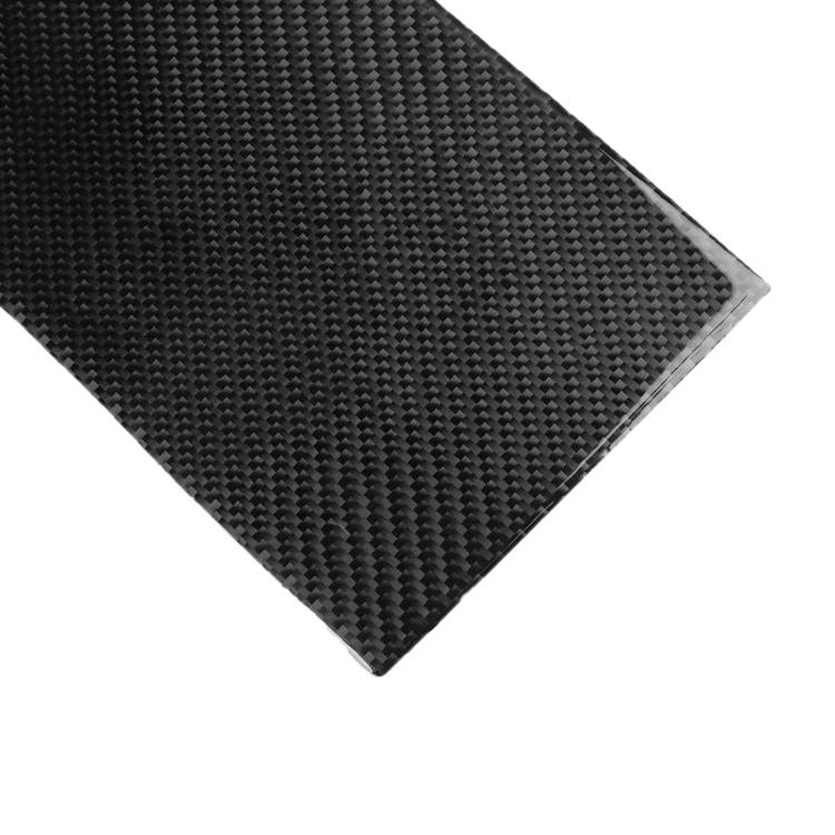Close-up of black carbon-fiber style rectangular storage panel sticker corner