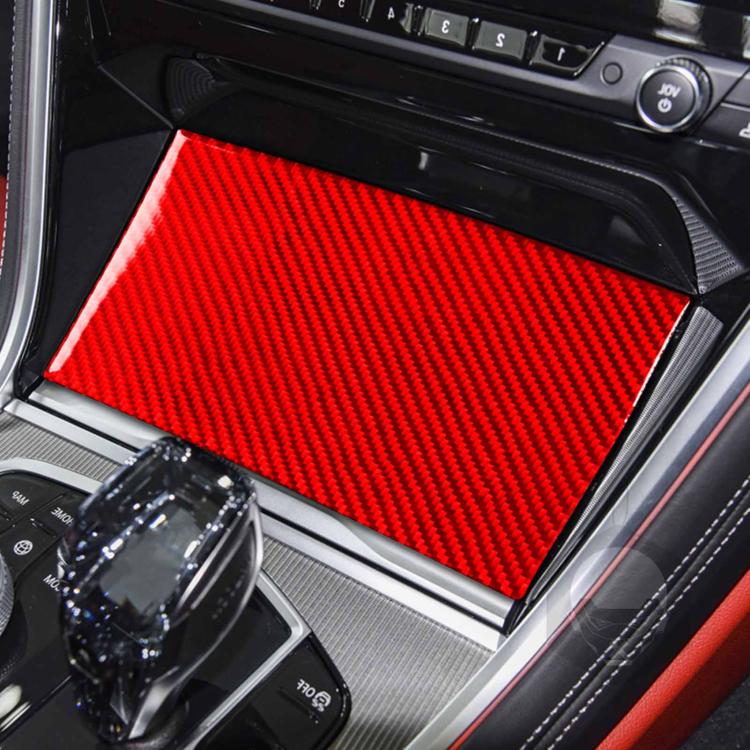Red carbon-fiber style sliding storage panel sticker installed in car console cubby