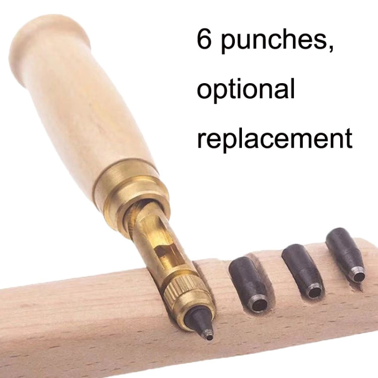 Wood-handled belt punch with multiple black punch dies on a wooden board