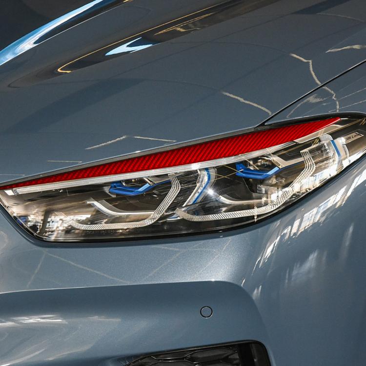 Red carbon-fiber headlight eyebrow sticker installed along the front headlight